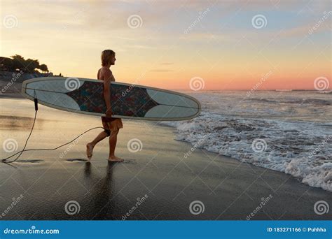 Surfer Surfing Man With White Surfboard Walking On Sandy Beach Water