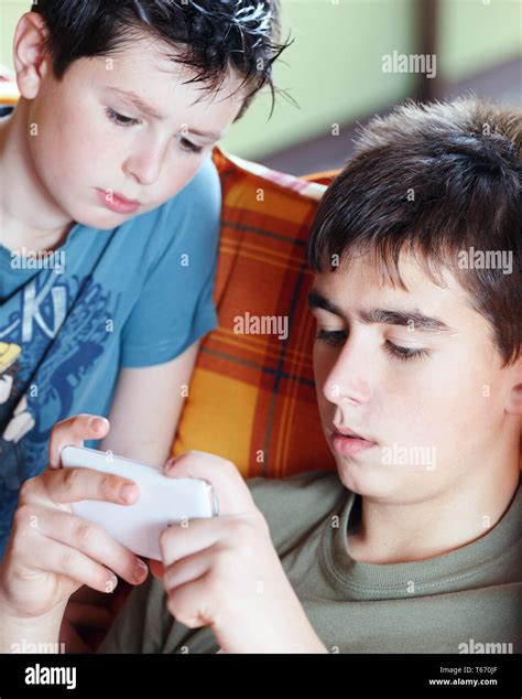 Teenager Boys Playing On Smartphone Outdoor Stock Photo Alamy