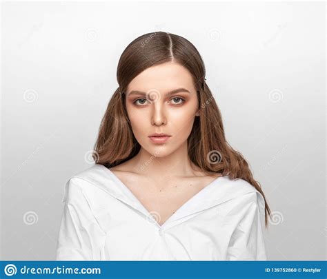 Portrait Of A Beautiful European Fashion Model On A Gray Background