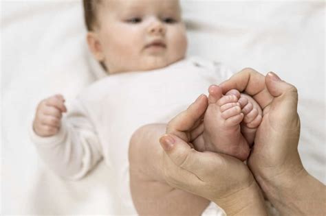 Mother Holding Childs Feet Stock Photo