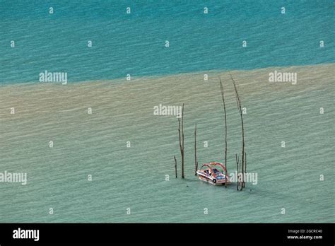 Boat Turquoise Water Of Mountain Lake Flooded Trees Stock Photo Alamy