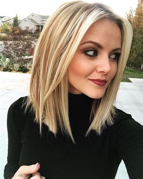 medium length layered hair woman with blonde hair wearing black polo blouse lob hairstyle lob