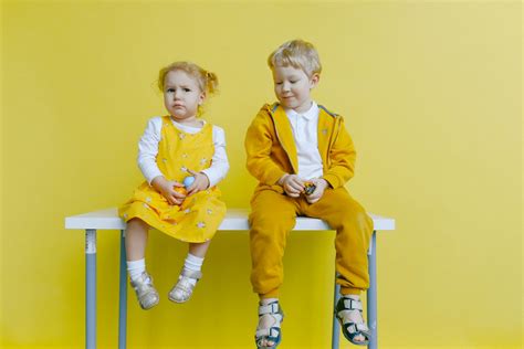 Siblings Sitting On A White Table · Free Stock Photo