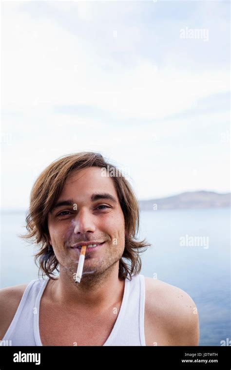 Young Man Smoking Cigarette Stock Photo Alamy