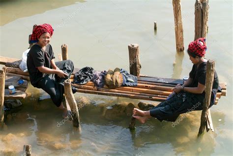Women Washing Clothes On The River At Indein On Inle Lake Stock