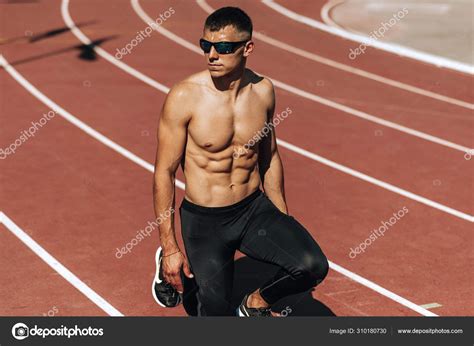 Image Of Shirtless Young Athlete Man Preparing For Running On Racetrack At Stadium Sportsman