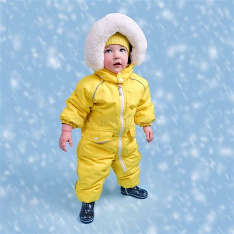 Happy Toddler Baby In Winter Clothes Snowsuit Kisu On Studio Blue Bac