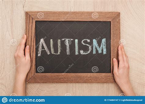 Cropped View Of Woman Holding Chalkboard With Autism Lettering Stock