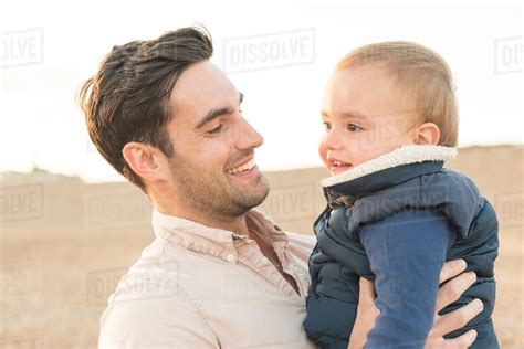 Father Hugging Young Son Outdoors Stock Photo Dissolve