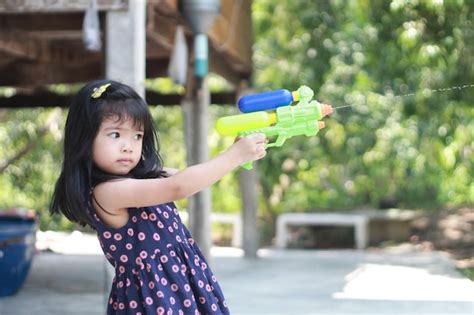 Premium Photo Girl Playing With Squirt Gun
