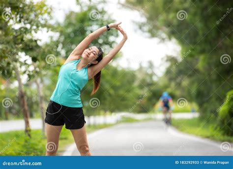 Healthy Woman Warming Up Before Jogging Run And Relax Stretching Her
