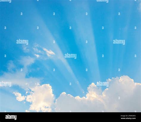 Sunrays Passing Through Clouds And Blue Sky Stock Photo Alamy