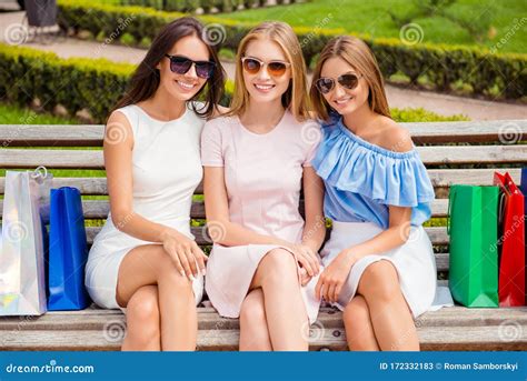 Three Beautiful Girls In Spectacles Sitting On Bench After Shopping Stock Image Image Of