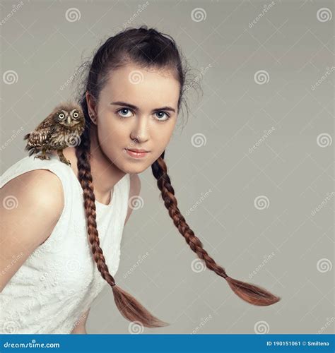 Portrait Of Female Girl With Pigtails Hairstyle And Baby Owl On The