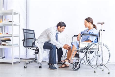 asian doctor give advice and examination about knee joint for pretty patient at hospital or