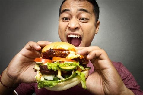 Guy Eating A Hamburger With Many Toppings Burger Toppings Burger Full Meal Recipes