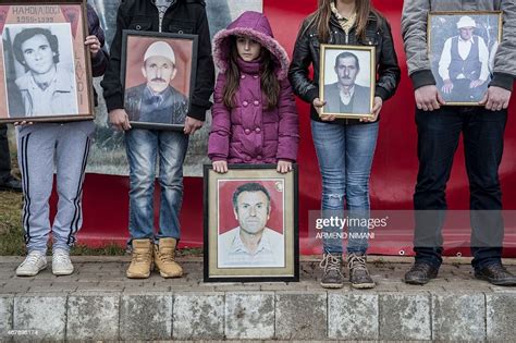 Kosovo Albanians Hold Pictures Of Their Relatives Killed During The