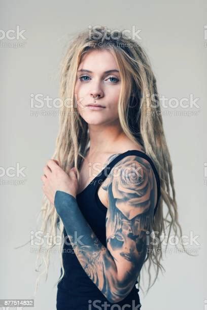 Portrait Of Tattooed And Pierced Young Women With Blond Dreadlocks