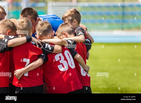 Children Sports Soccer Team Kids Standing Together On The Football