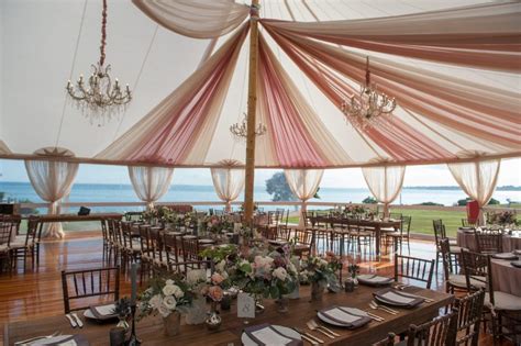The Inside Of A Tent With Tables And Chairs Set Up For A Formal