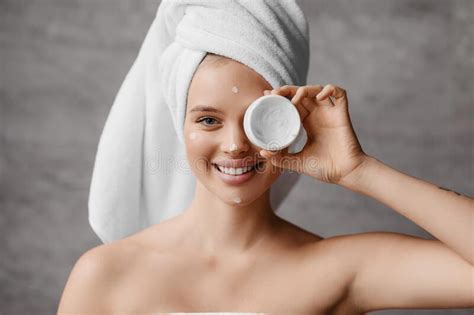 Moisturizing Skin After Shower Pretty Millennial Woman In Towel Covering Her Eye With Jar Of
