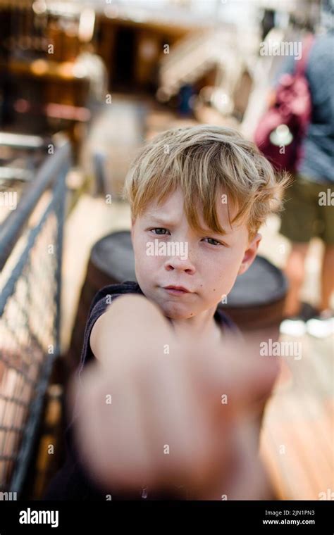 Eight Year Old Boy Sticking Hand In Front Of Camera In San Diego Stock