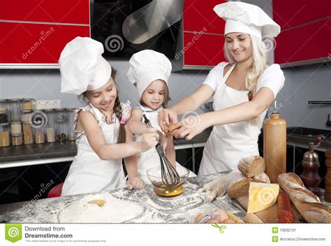 Moeder En Twee Dochters In De Keuken Stock Afbeelding