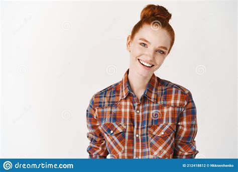 headshot portrait of happy ginger girl with freckles smiling looking at camera white background