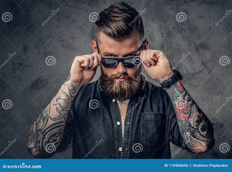 A Man With Tatoos On His Arms Royalty Free Stock Photography