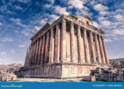 Ancient Roman Temple Of Bacchus With Surrounding Ruins And Blue Sky In