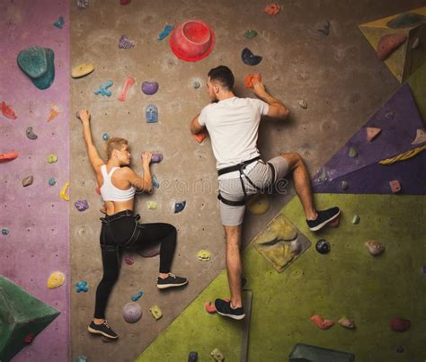Young Man Climbing Artificial Rock Wall At Gym Stock Photo Image Of Rock Clambering 108790416