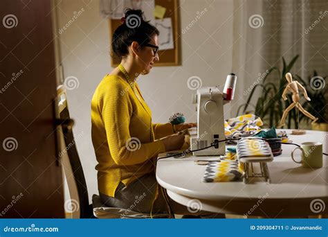 woman sewing on a sewing machine at her home stock image image of adult creative 209304711