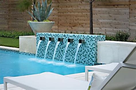 Although water features have very little to do with a pool's surface, they still give off a custom, classy, and permanent feel to the swimming pool. modern-pool-water-features-3 | Pool designs