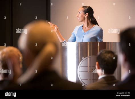 Businesswoman Giving Presentation At Podium Stock Photo Alamy