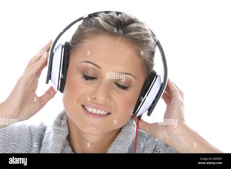 Attractive Young Woman Wearing Headphones And Enjoying Listening To