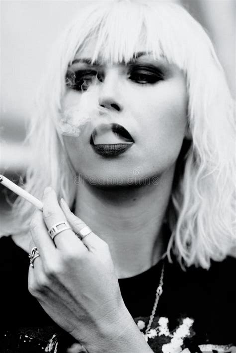 Portrait Of Stylish Blonde Grunge Young Woman Smoking Cigarette Stock