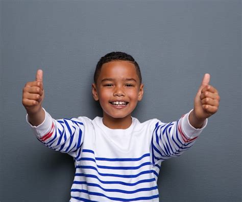 Premium Photo Happy Little Boy Showing Thumbs Up