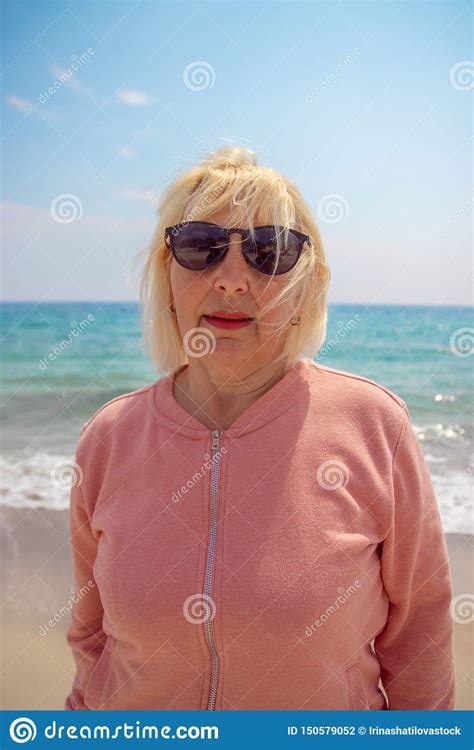 Happy Life Adult Blond Woman Walking On The Beach Of The Ocean On A Sunny Day Happy Life Stock