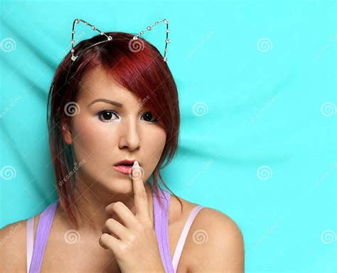 Redhead Girl With Cat Ears Holding Her Finger At The Lips Stock Image