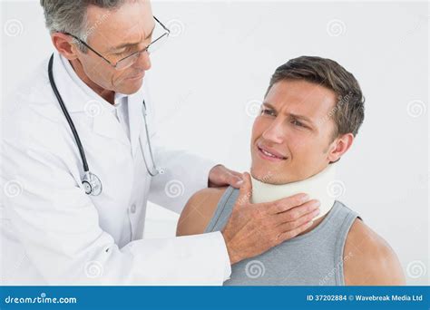Male Doctor Examining A Patients Neck Stock Photo Image Of Caucasian
