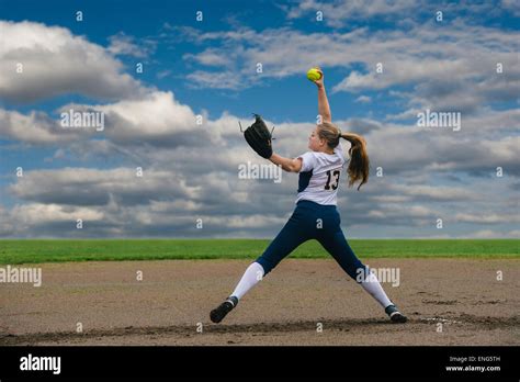 Caucasian Softball Player Pitching Ball In Field Stock Photo Alamy