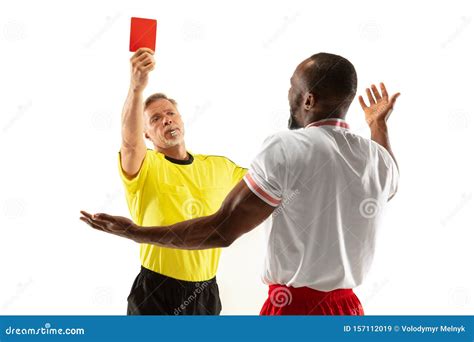 Football Referee Showing A Red Card To A Displeased Player Isolated On