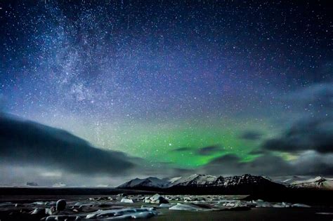 Online Crop Northern Lights Over Snow Covered Mountain