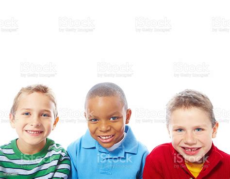 Portrait Of Three Small Boys Over White Background Stock Photo