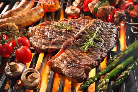 Delicious Grilled Meat With Vegetables Sizzling Over The Coals On