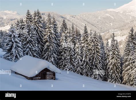 Log Cabin In A Snow Covered Landscape In The Austrian Alps Stock Photo