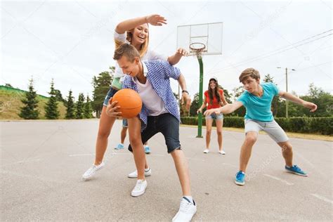 Group Of Happy Teenagers Playing Basketball — Stock Photo © Syda