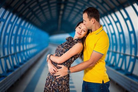 Premium Photo Young Adult Couple Enjoying Their Love And Posing In Futuristic Blue Tunnel