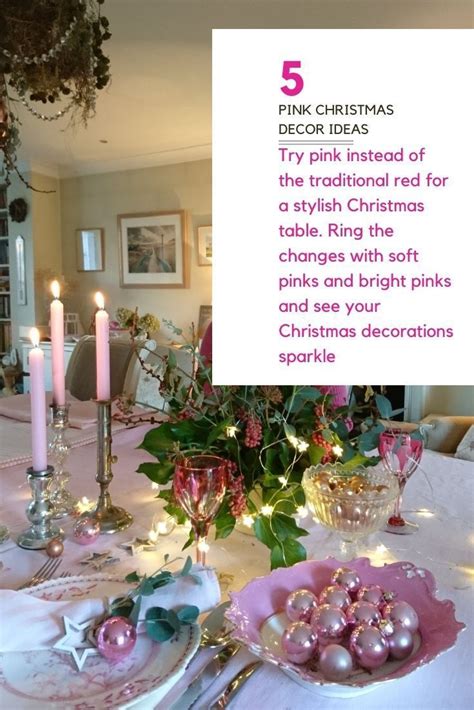 The Table Is Set For Christmas With Pink Decorations And Candles On It
