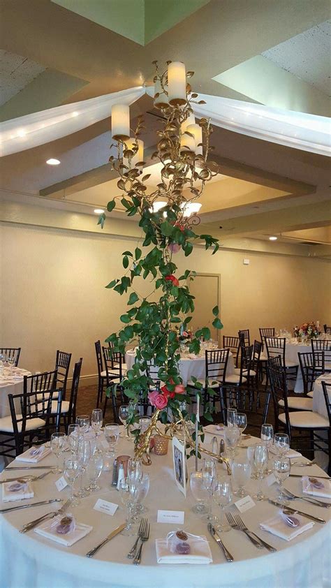 Smilax Wrapped Around Tall Gold Candle Stands Make Stunning